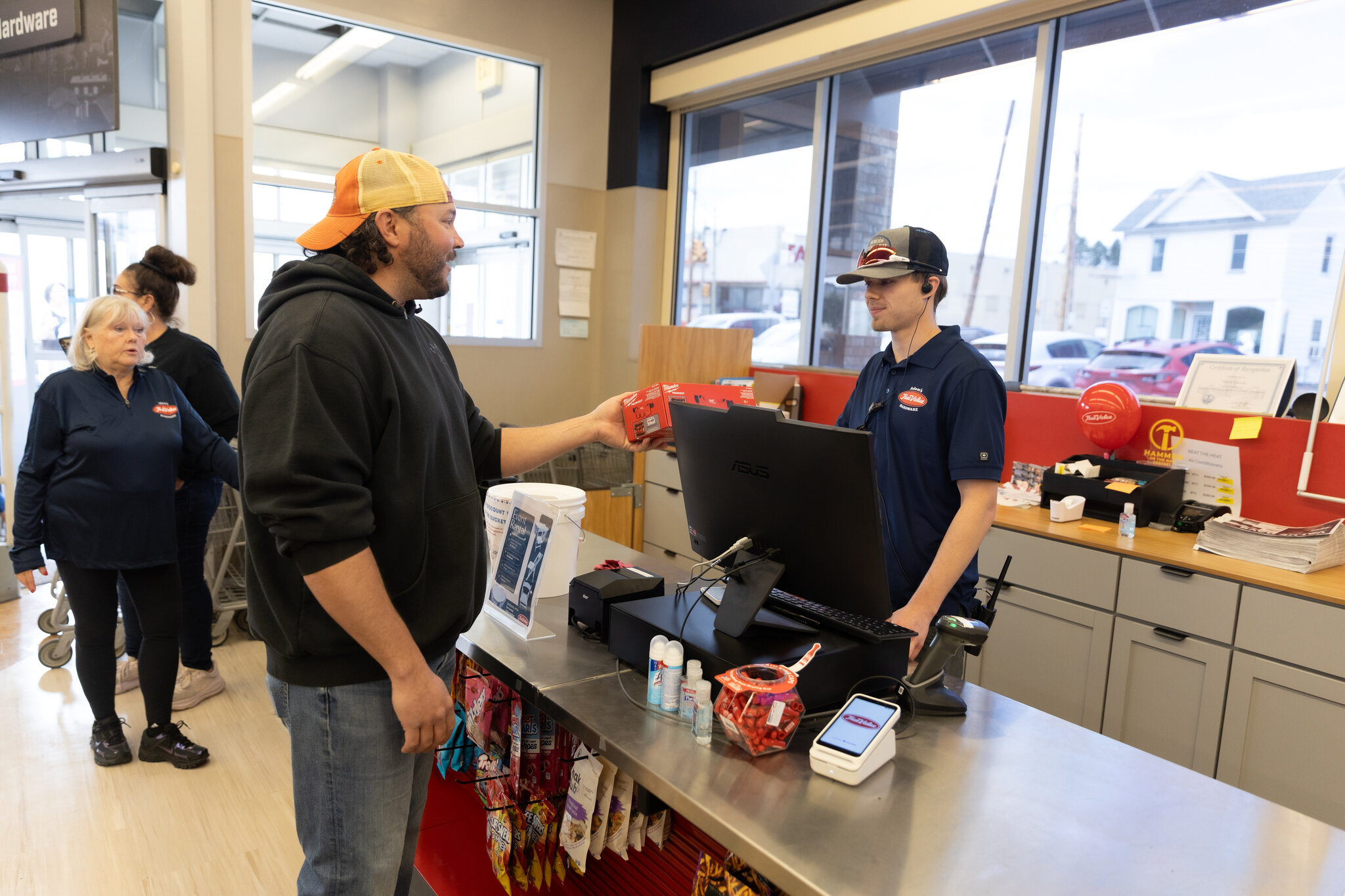 A customer being rung up at the front counter of Adam's True Value Hardware