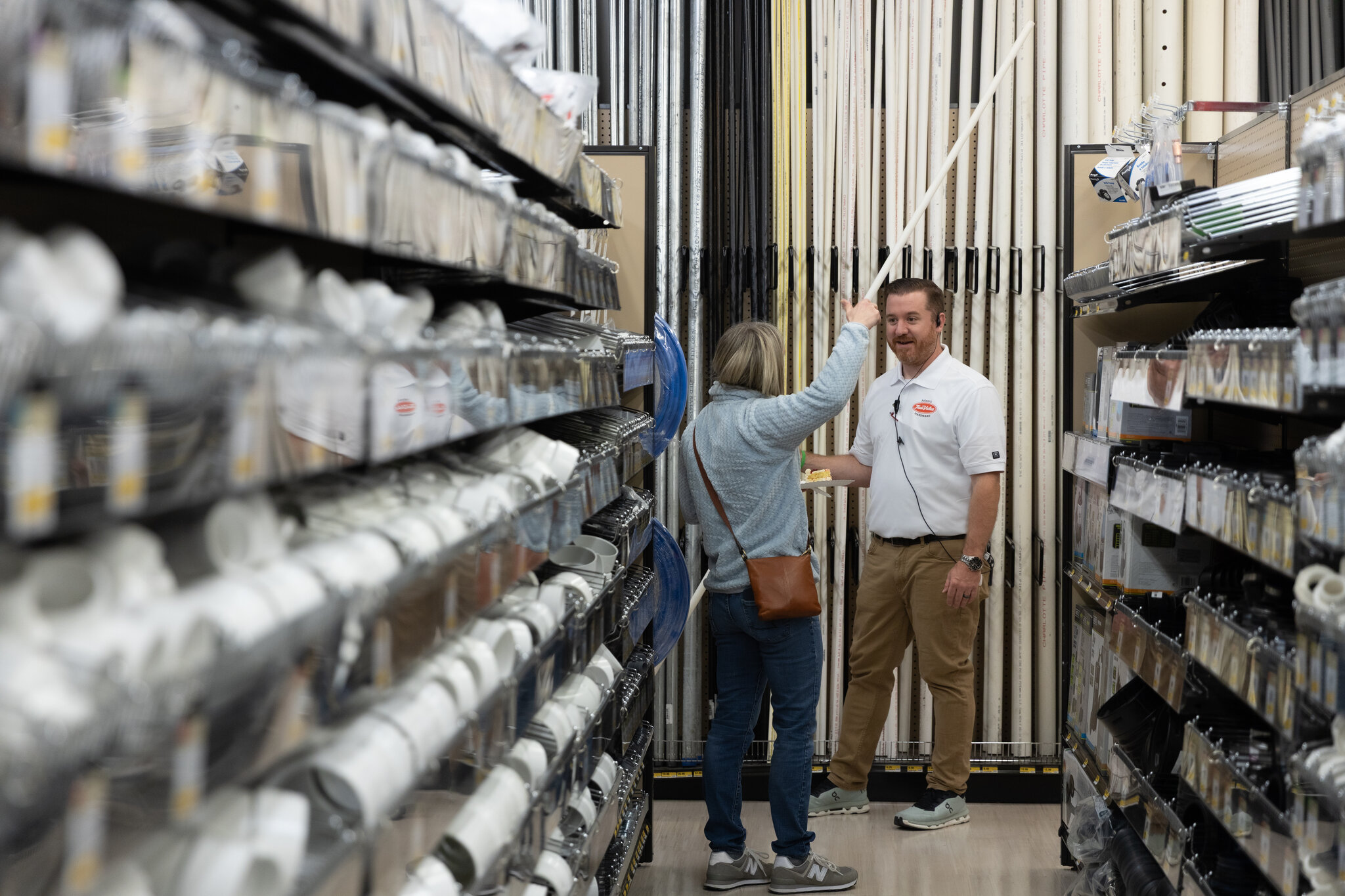 A Taffera brother helping a customer in the plumbing aisle at Adam's True Value Hardware