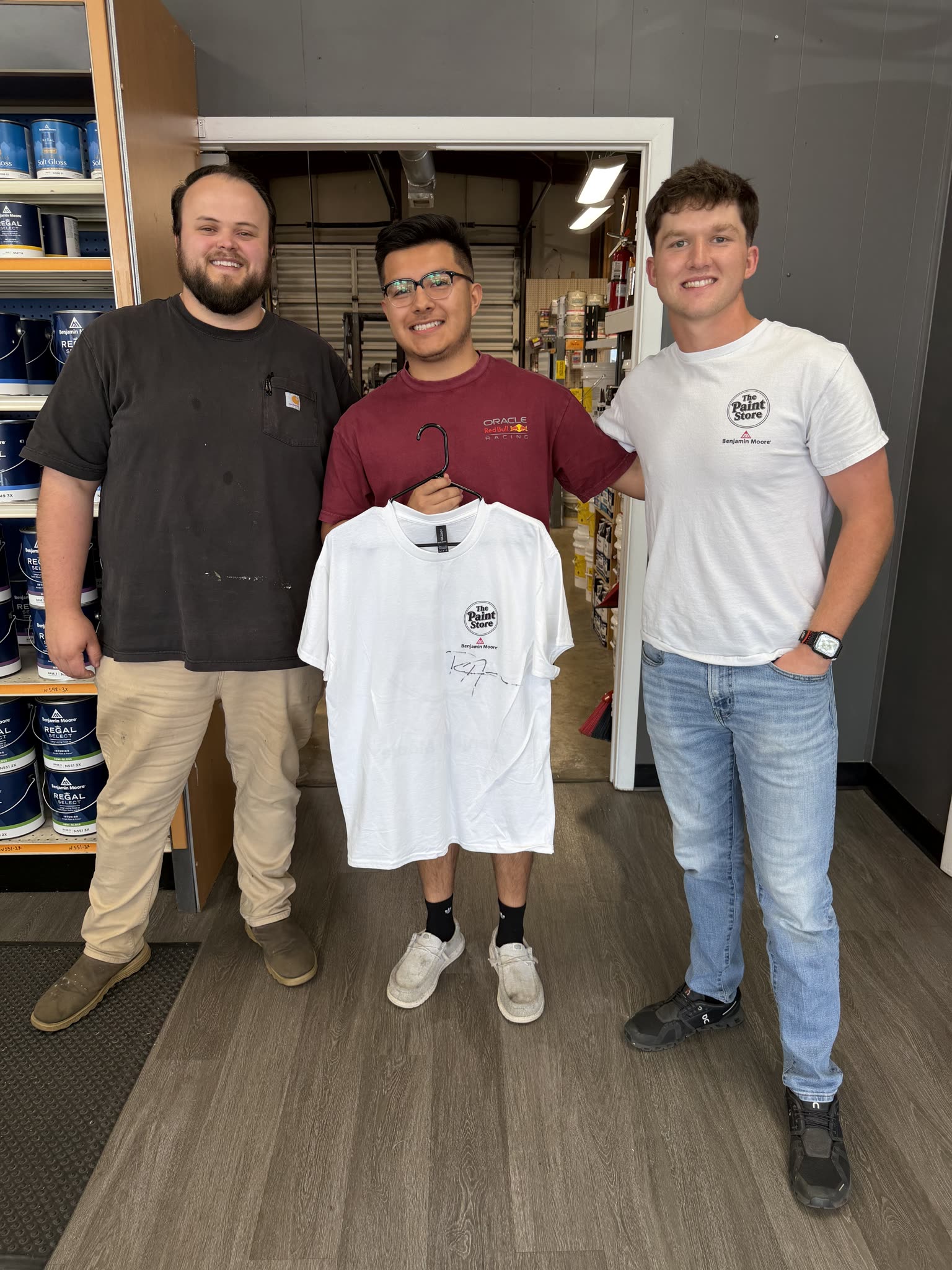 Three of the team at The Paint Store in Cookeville, Tennessee, holding their signed Rundoo go-live shirt