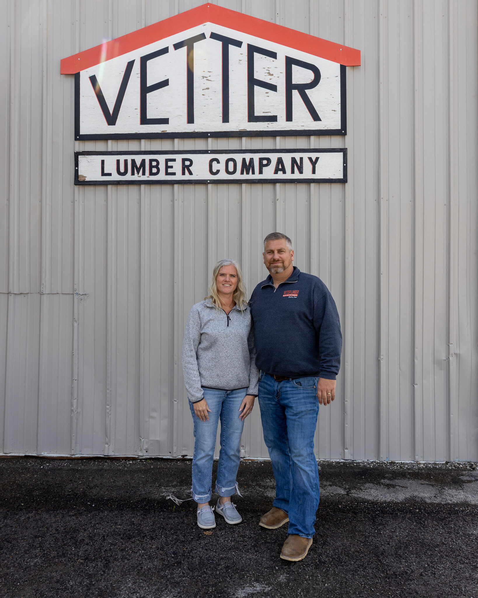 Tammy and Jason Kinsinger in front of the Vetter Lumber Company sign