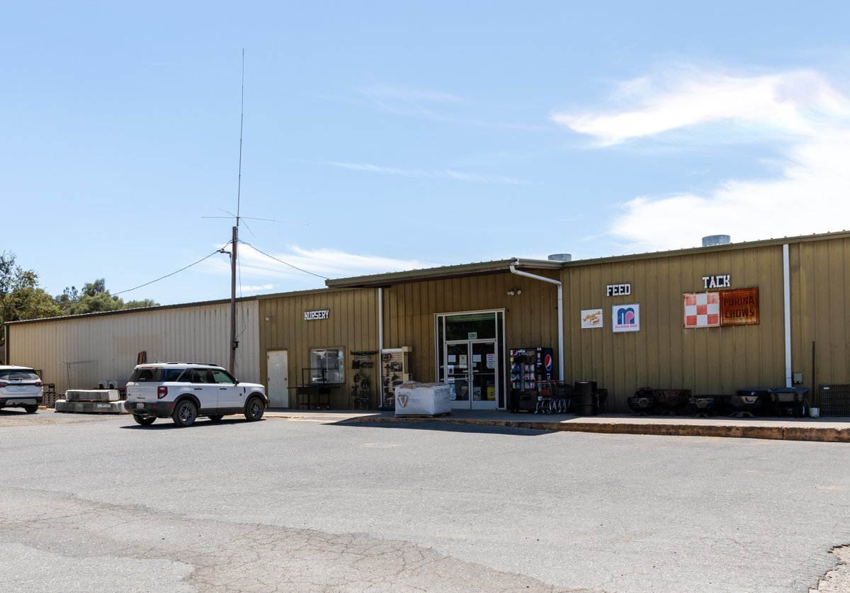 The storefront at Spence Ranch Feed Supply, with feed, tack and nursery signage