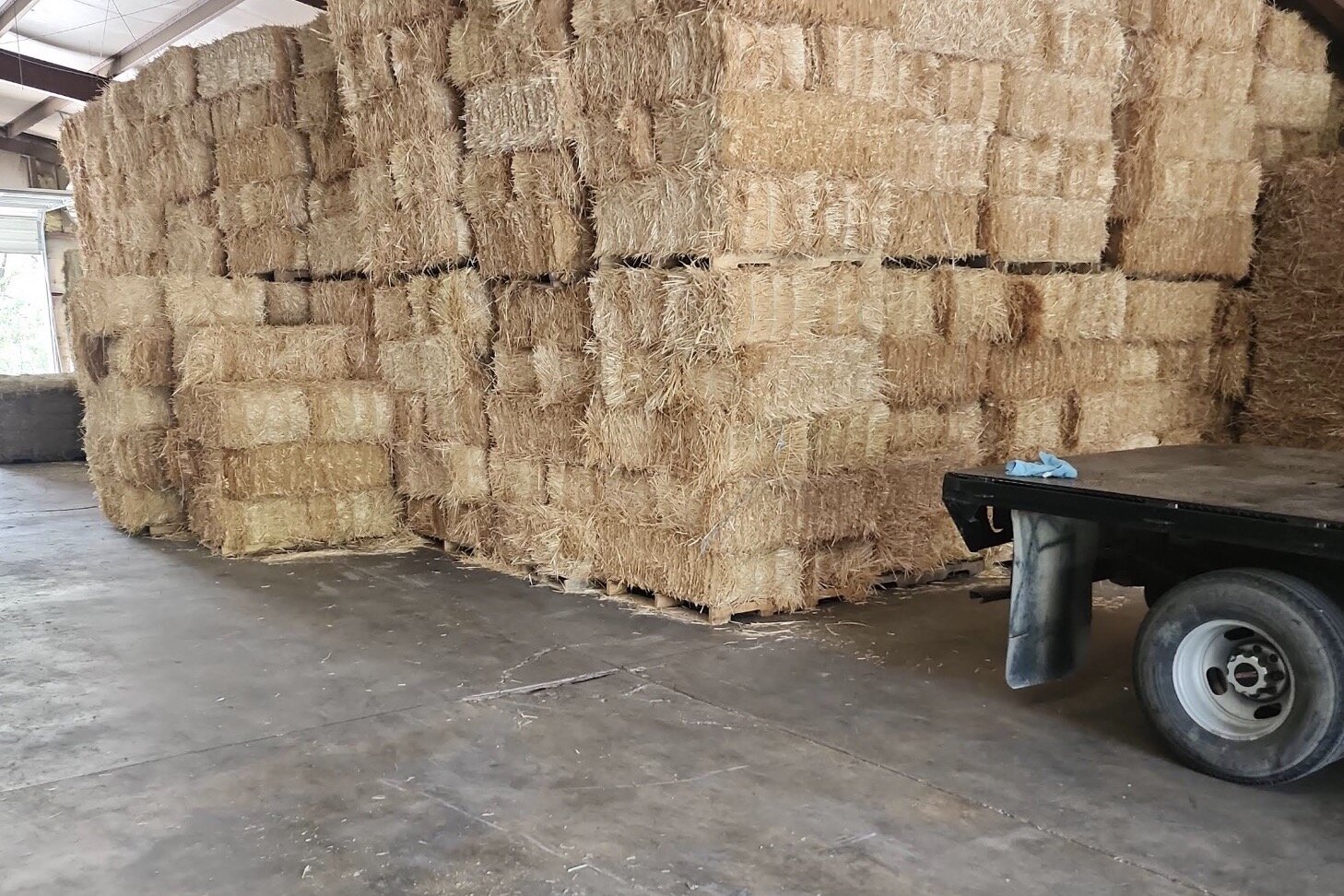 Hay stacked to the roof in the warehouse at S&T Farm Supplies