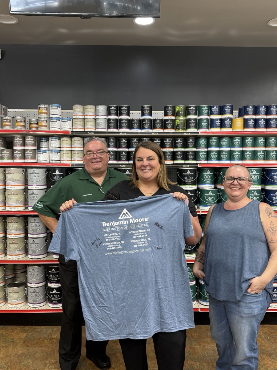The Burlington Design Center team holding their signed Rundoo go-live shirt.