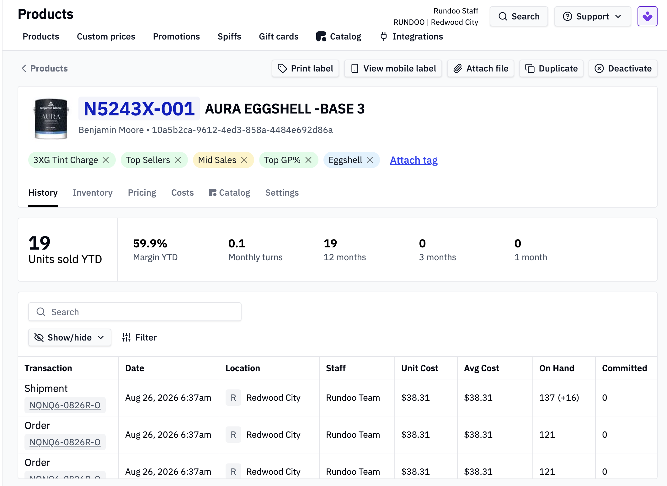The same Aura Eggshell base in Rundoo, with units sold, margin and stock turns above a transaction history showing location, staff and cost.